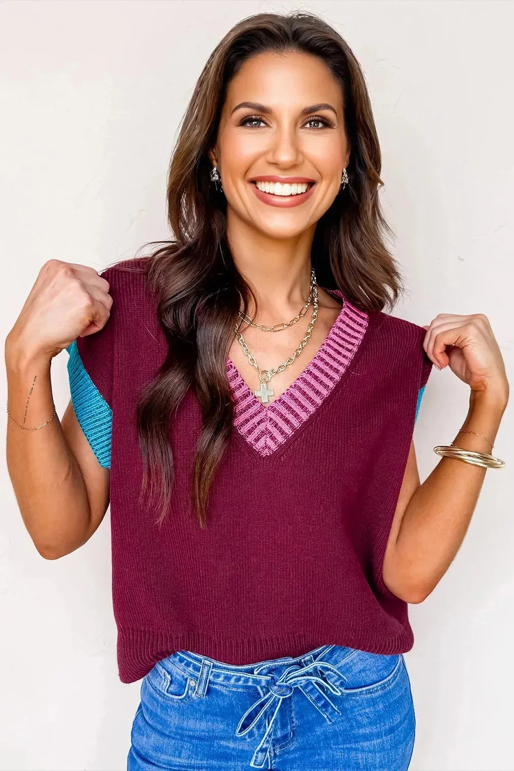 Burgundy loose-fit V-neck sweater with contrast trim on the cuffed short sleeves.