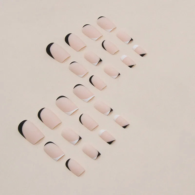 Black and white frosted French manicure artificial nails on display