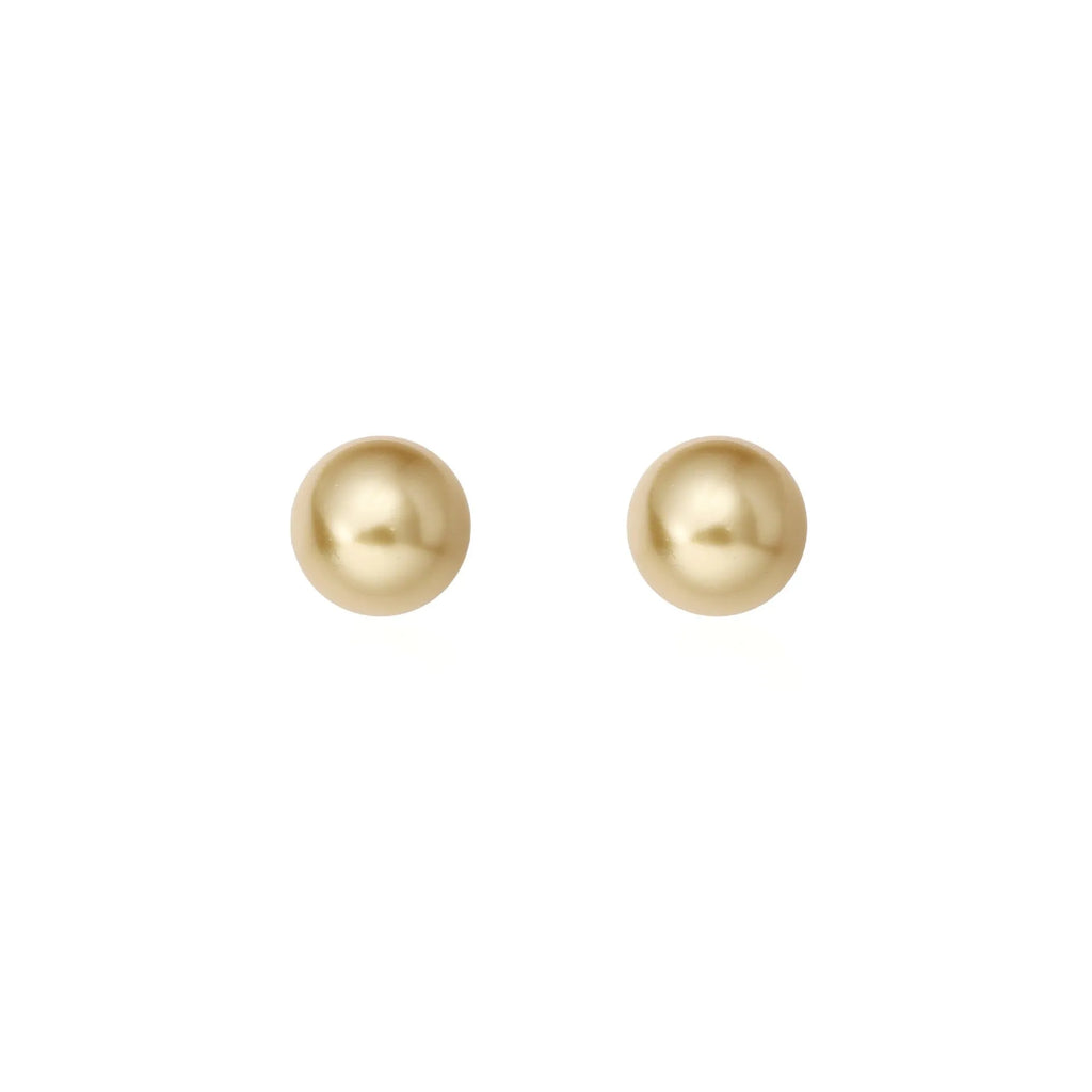 A pair of large geometric pearl stud earrings with an eight-point star detail on a silver setting.
