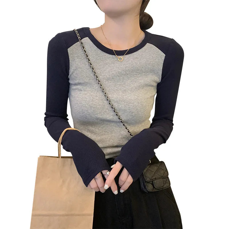 Women's black viscose top with embroidery and long princess sleeves on a hanger.