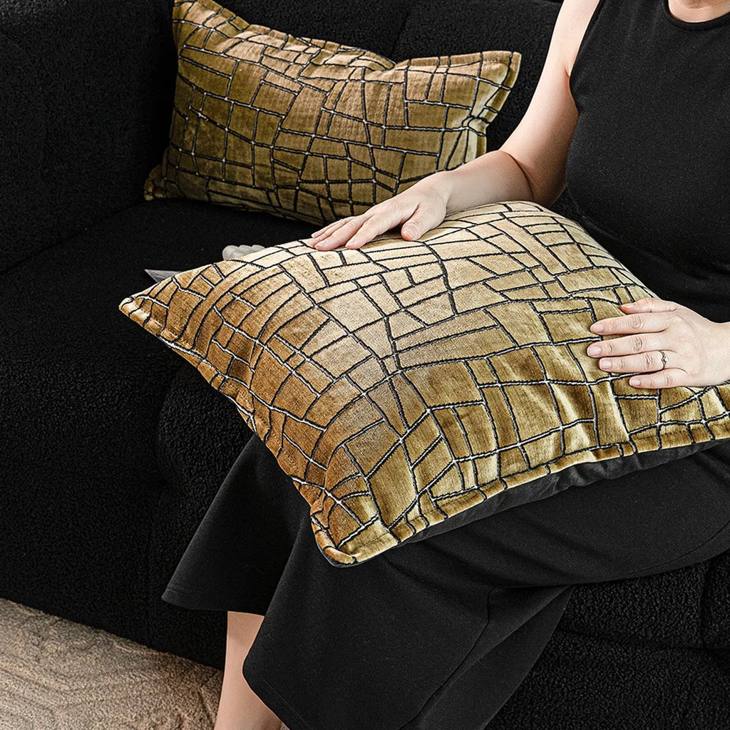 Tuhao gold geometric abstract pattern on a velvet square cushion cover and lumbar pillow.