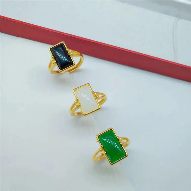 Adjustable brass electroplated ring with gold plating and embedded gemstones in black, green or white options
