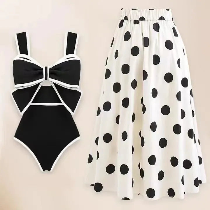 Women's black one-piece swimsuit with white bow and attached round skirt