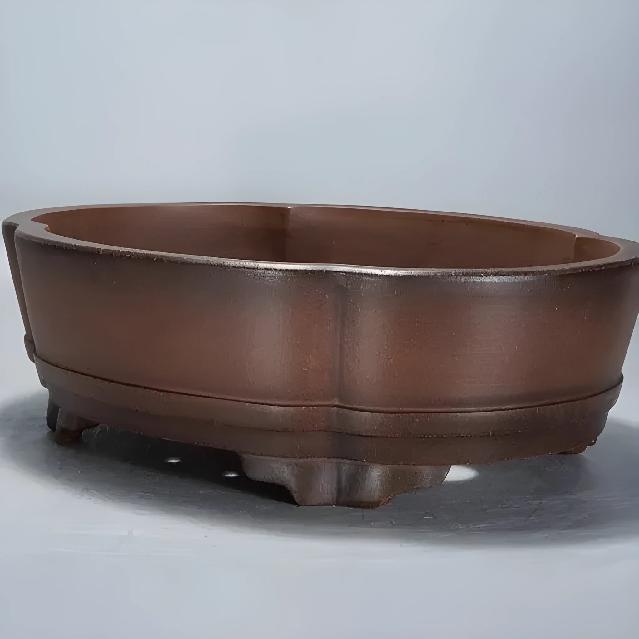 Classical style purple clay bonsai flower pot for indoor plants on a tabletop.