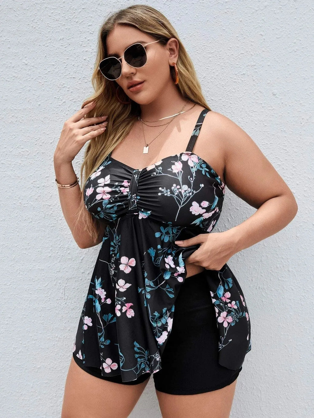 Women's floral print one-piece swimsuit with split colour design on a mannequin.