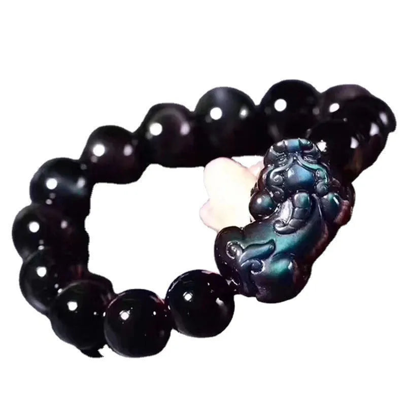Natural ice colour eye obsidian crystal bracelet on a wrist, showing polished beads.