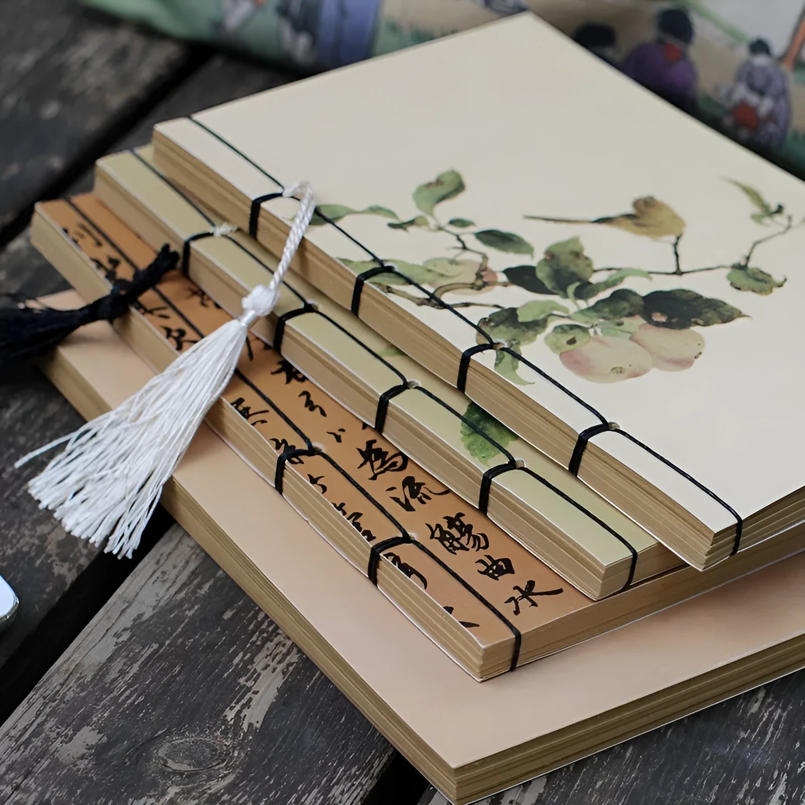 A5 antique wire-bound notebook with glossy embossed cover featuring a retro painting design, shown open.