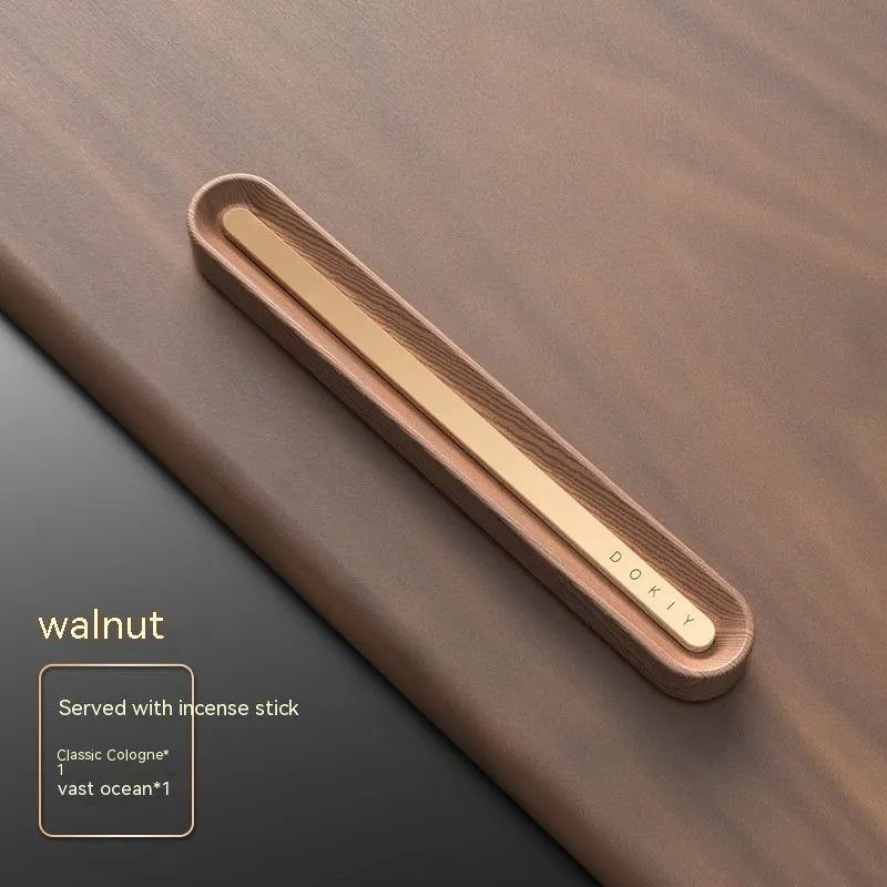 Long strip car aromatherapy ornament in walnut colour, shown clipped to a car air vent.