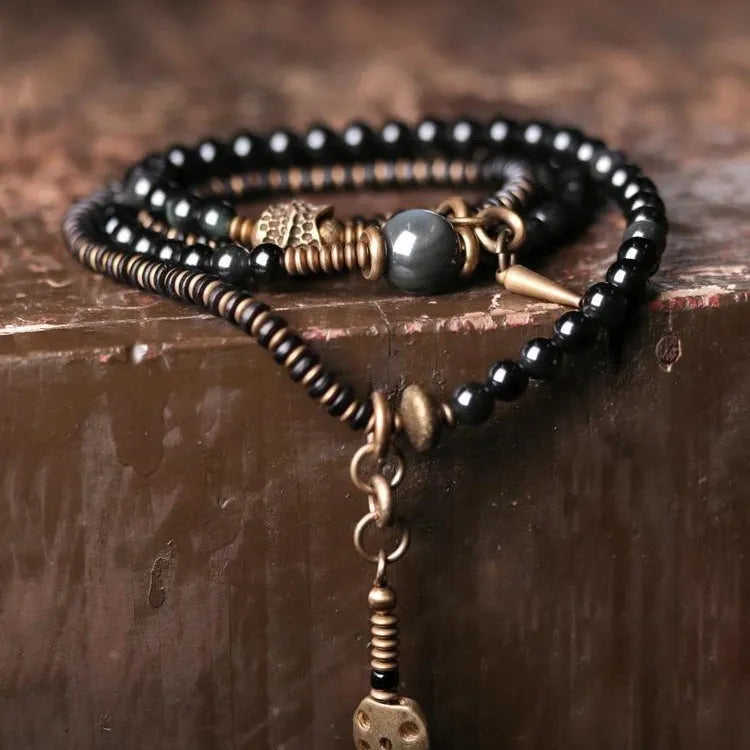 Black geometric beaded bracelet with colourful multi-layered retro design and adjustable cord