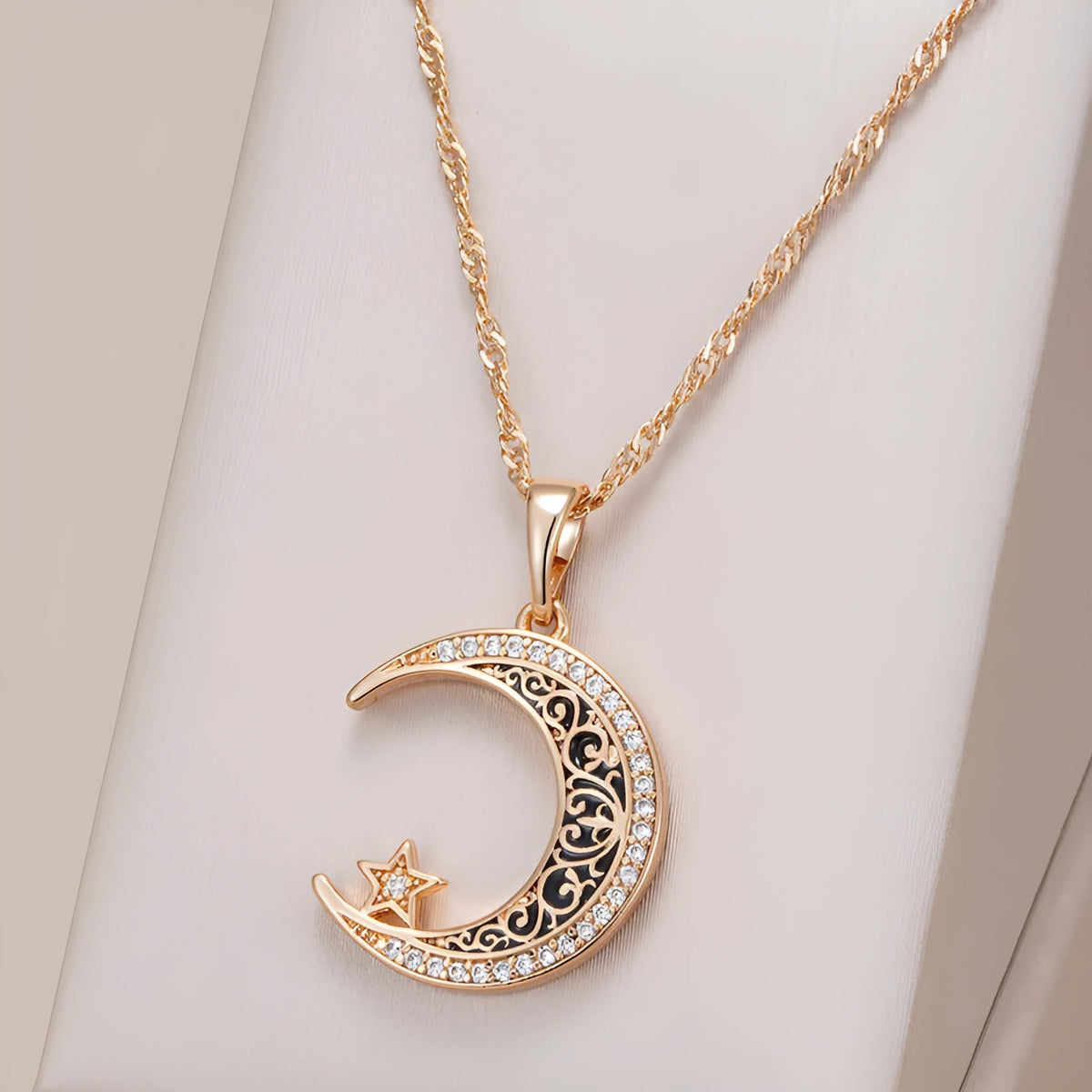 Rose gold star and moon pendant necklace with zircon stone on an adjustable water wave chain.