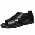 Men's black leather Roman sandals with open-toe design and rubber soles.