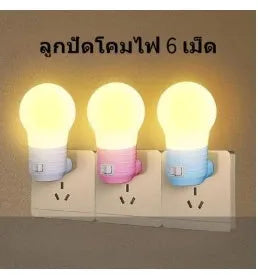 Plug-in baby night light in white shell on a nursery bedside table