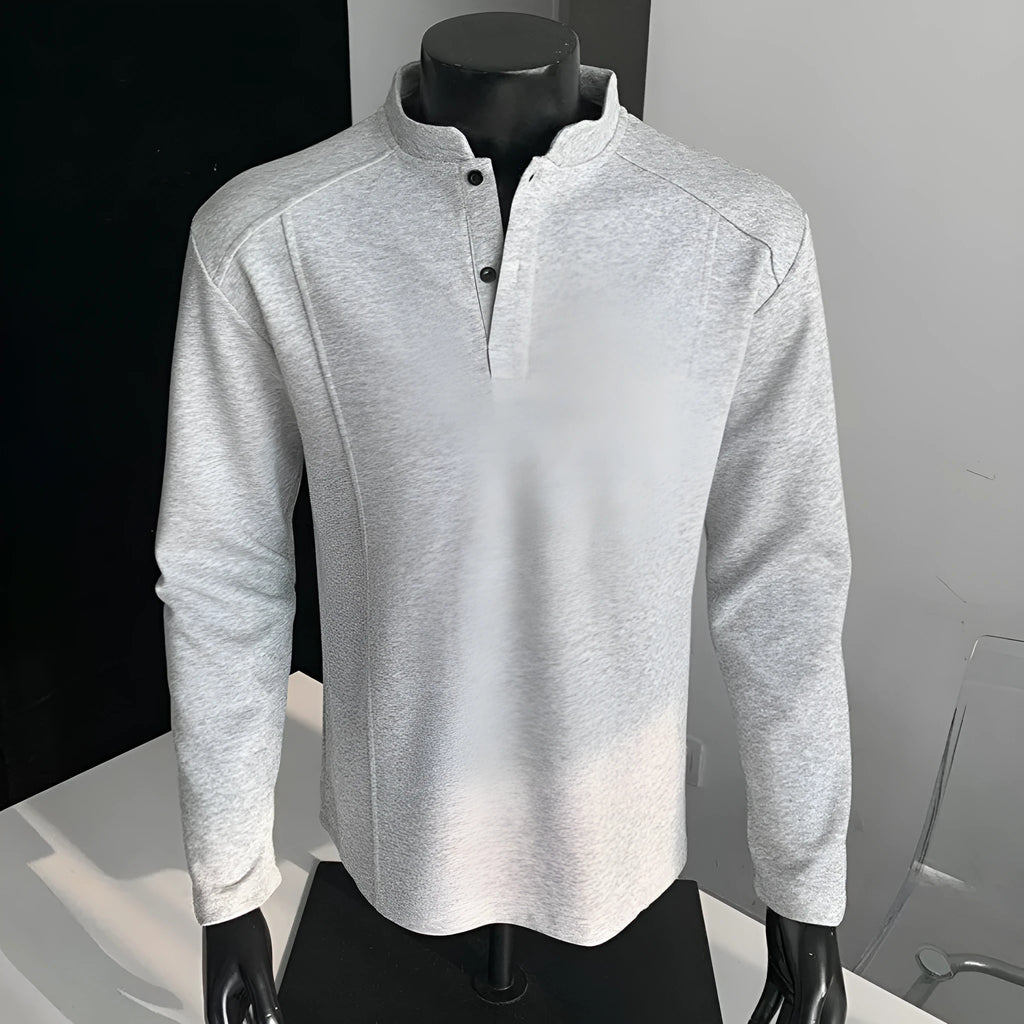 Men's loose fit cotton polo shirt with a stand-up collar and long sleeves in a solid colour.