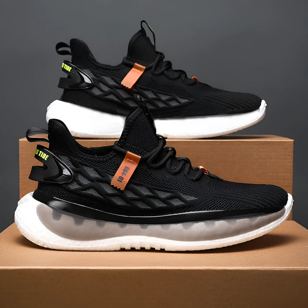 Men's low-top casual sneaker in woven mesh with a round toe and flat rubber sole.