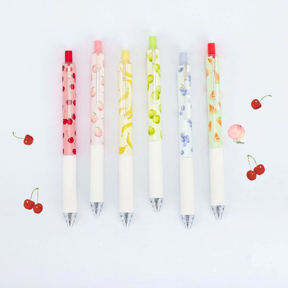 Three fruit scented press-action pens with 0.5mm tips and black ink refills