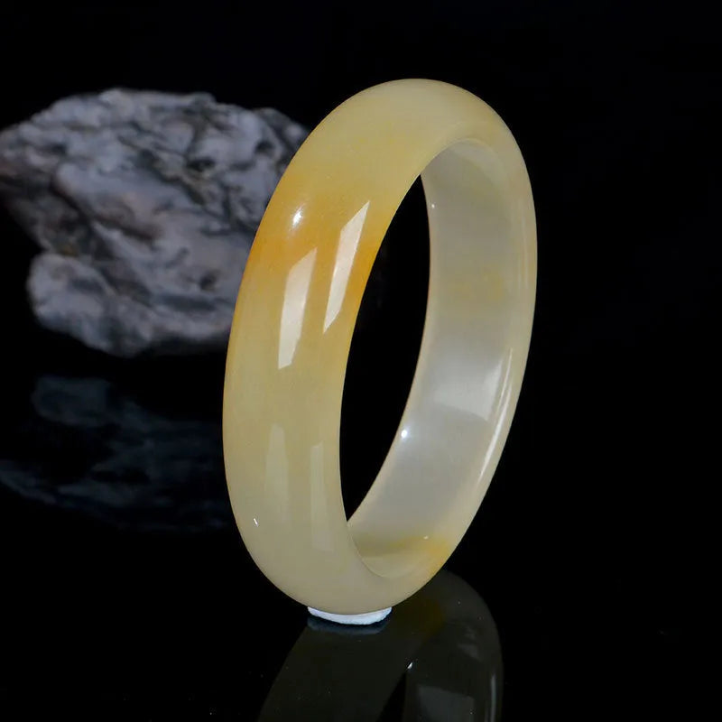Natural light jade bracelet for women showing polished Chinese style design on wrist