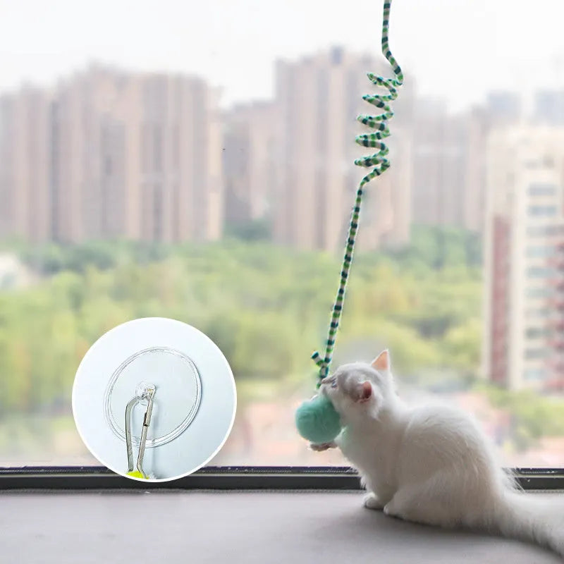 Hanging cat toy with colourful spring bell stick and inflatable ball attached to clear suction cup
