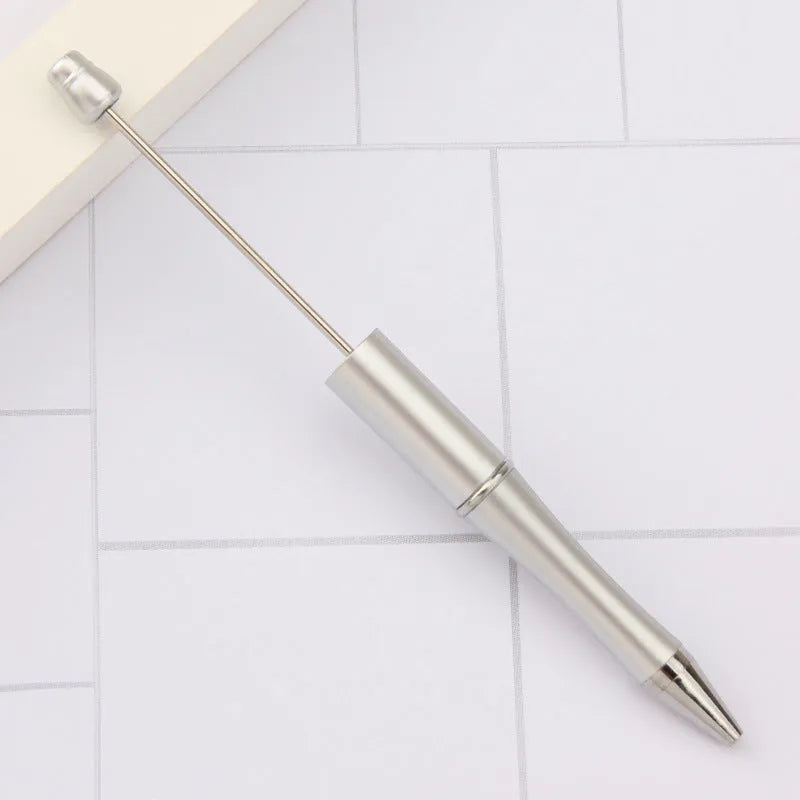 Ballpoint pen with colourful spinning plastic beads on barrel, shown in a gradient purple finish.