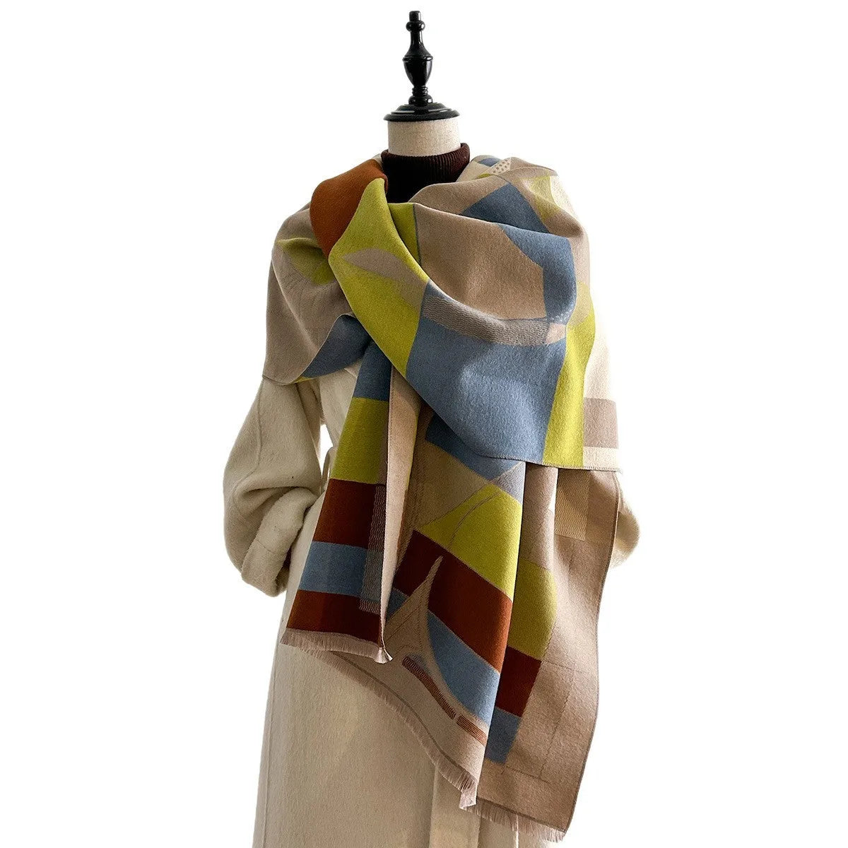 A long beige imitation cashmere scarf draped to show its 185cm length and texture.