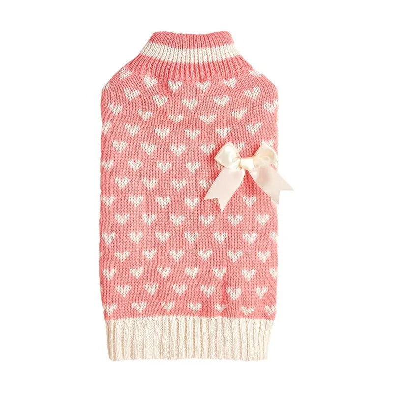 Red dog sweater with love heart design and bow decoration on small dog