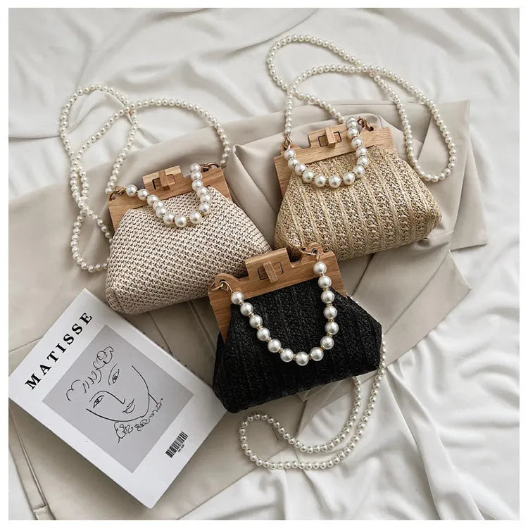 Women's woven straw beach bag with pearl chain shoulder strap in horizontal square shape