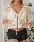 Women's apricot hollow woven cardigan blouse with short length and bell sleeves on a model
