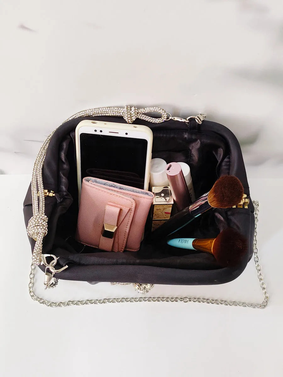 Women's soft polyester messenger bag with chain detailing and diamond pattern in black colour