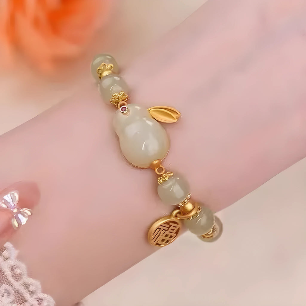 Women's black adjustable bracelet with green jade fu character, jade hare charm, and Lily decorations.