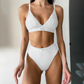 Ladies black bikini set with white contrast embroidery binding on sleeveless top and shorts.
