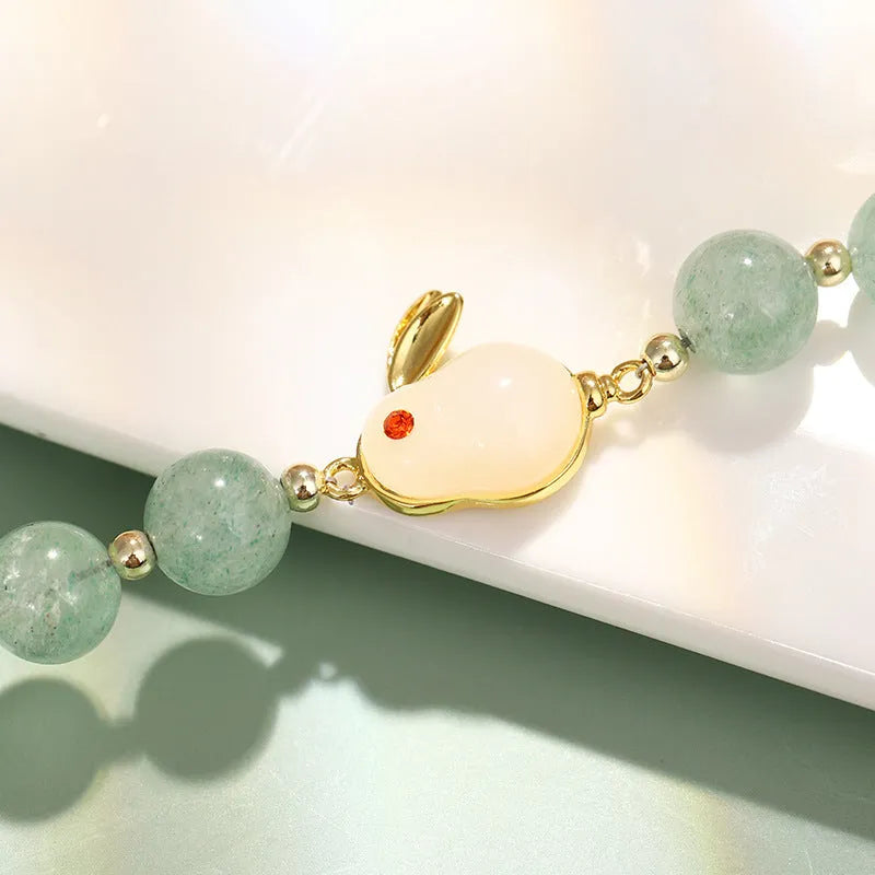 Rabbit charm bracelet with natural stone beads on copper-plated chain with gold accents