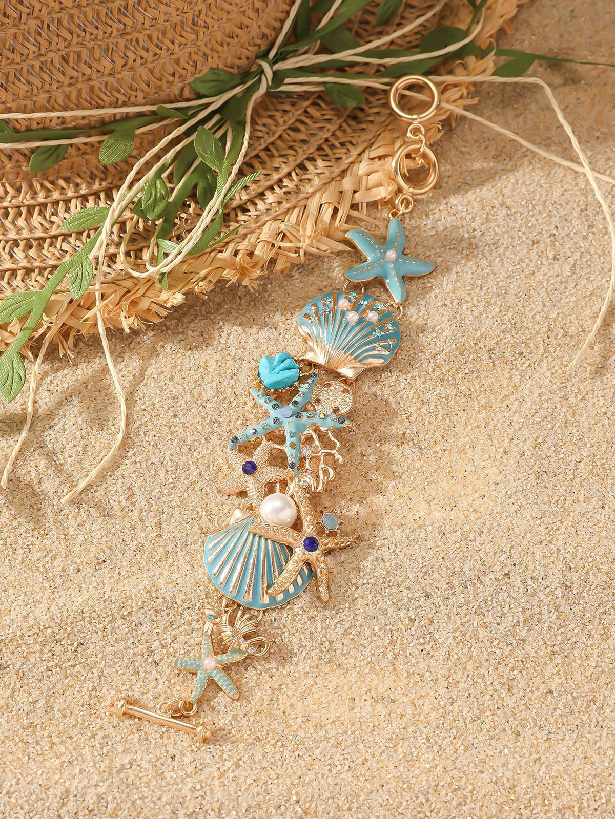 Women's alloy marine bracelet with boat anchor and starfish charms in turquoise, red, or blue coral colours.