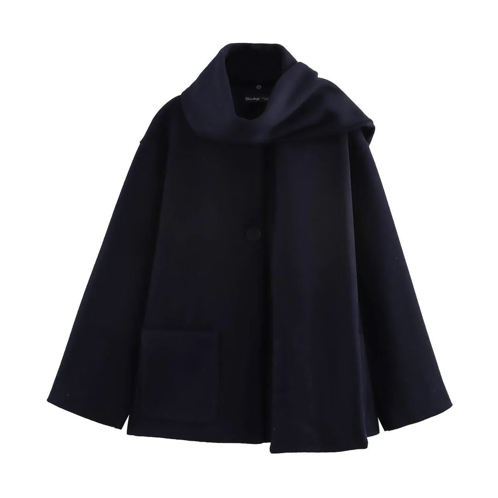 Women's long grey coat with artificial fur collar, shown with pockets and street-fashion styling.