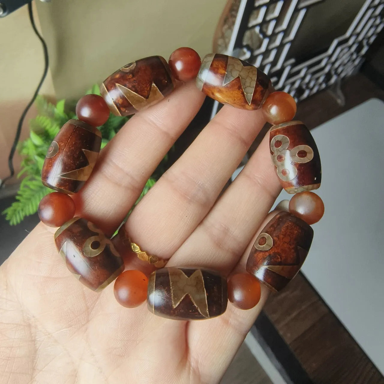 Distressed agate bracelet with traditional Tibetan dzi beads including three-eye and Nine Eyes designs.