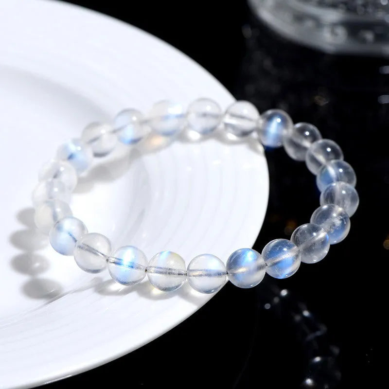 Natural cream body blue moonlight crystal bracelet shown in a simple unisex design on a wrist.