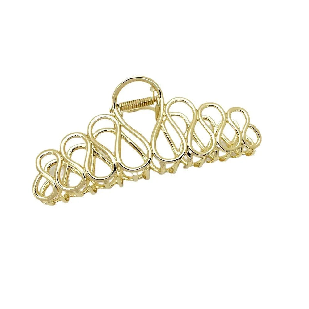 Large minimalist updo hair clip with tassel detail in gold or silver electroplated finish.