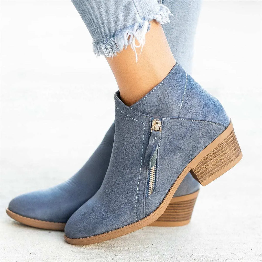 Women's beige suede ankle boots with a side zip and a chunky block heel.