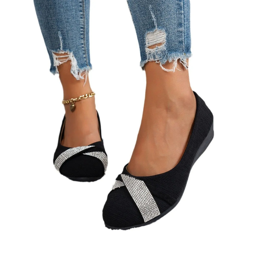 Black women's slip-on casual shoes with rhinestones on the fabric upper and a chunky heel.