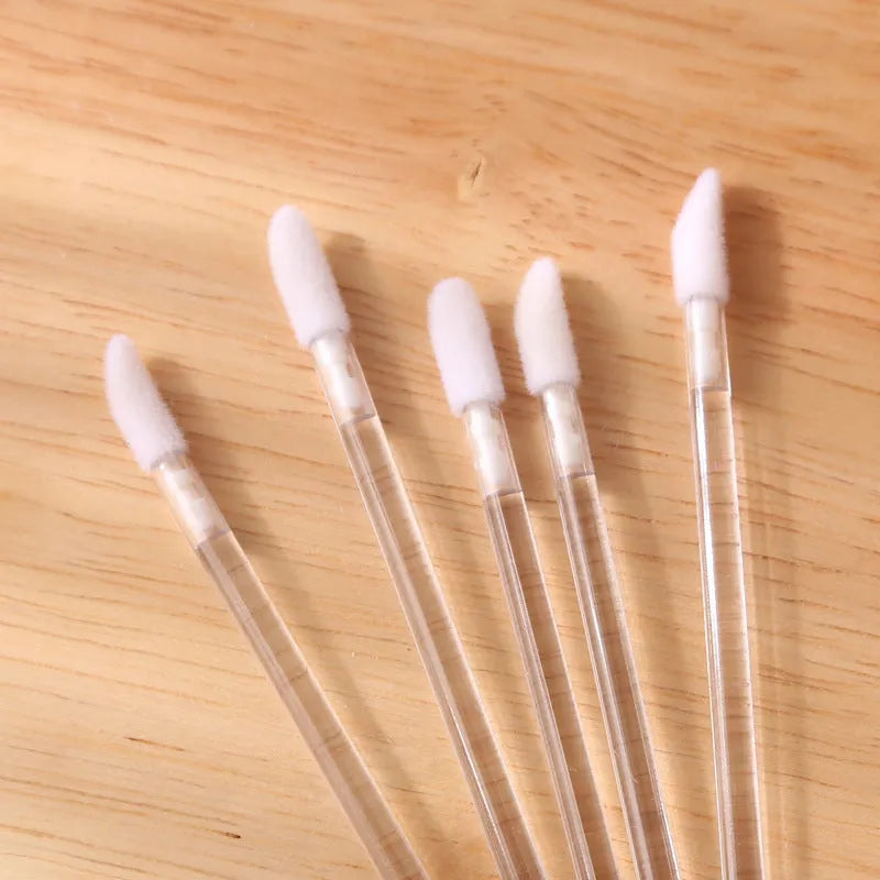 Pack of multi-colour disposable lip brush applicators with black handles and soft flocked tips.