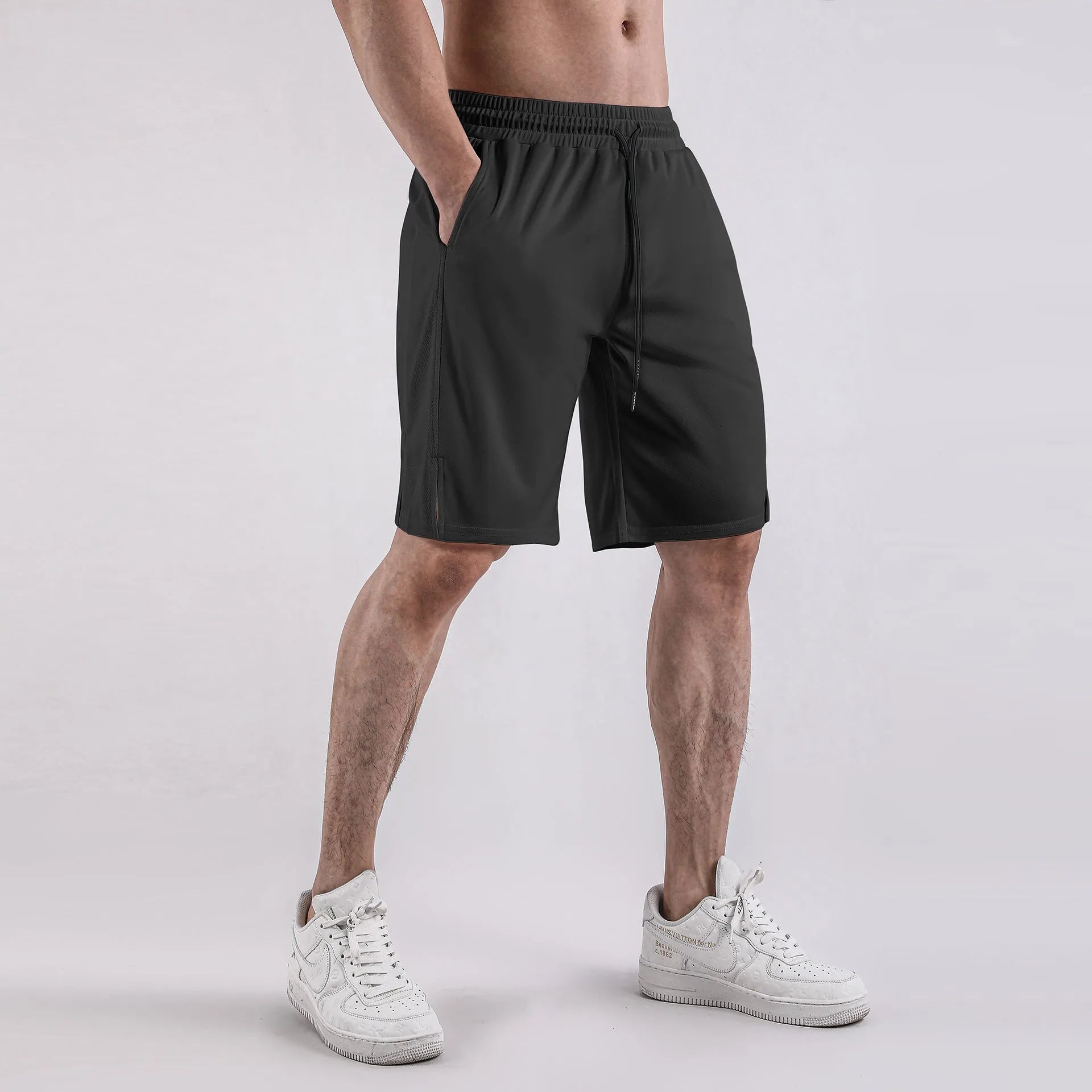 Men's black quick-dry mesh fitness shorts with elastic waistband and loose fit