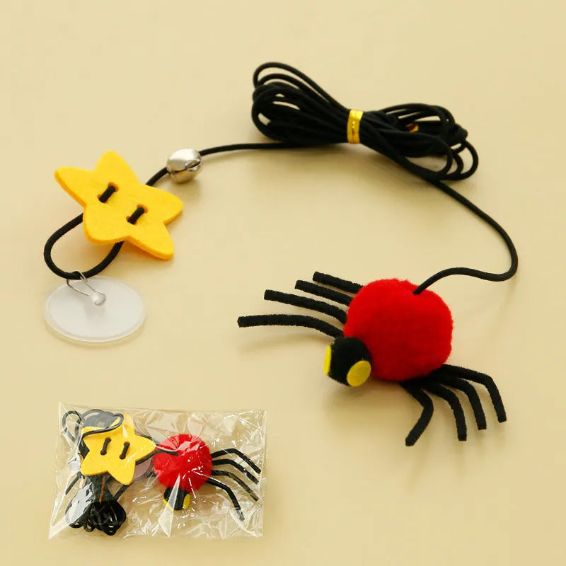 Red and yellow hanging door cat toy with elastic rope, feather, bell, and spider attachments