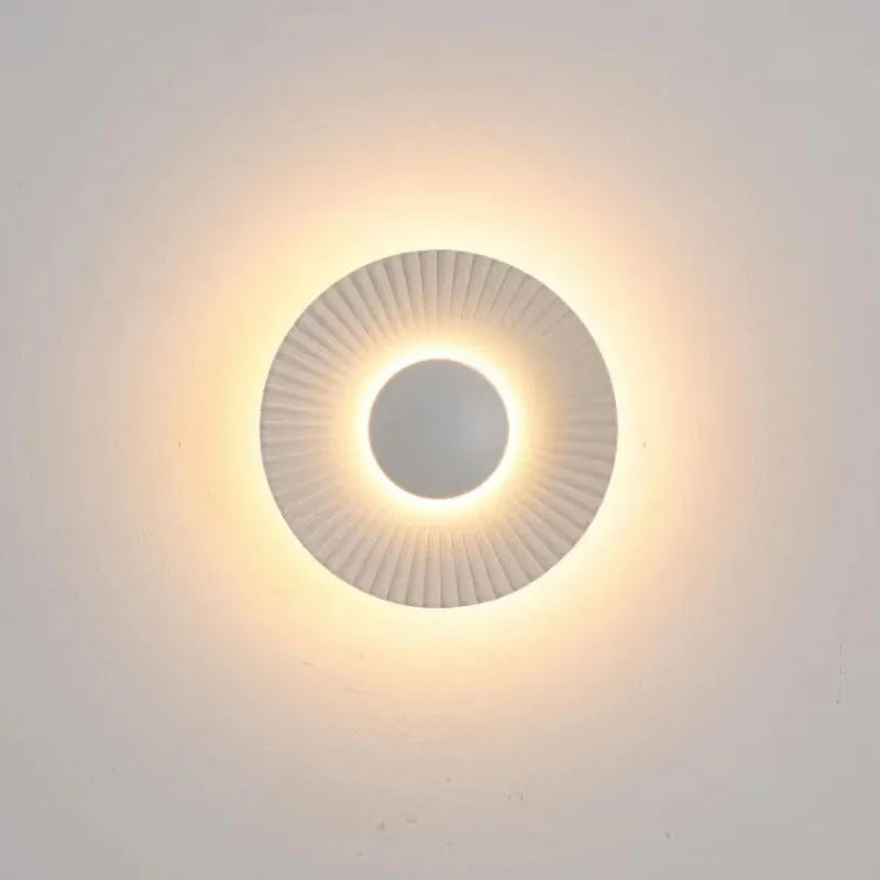 Round aluminium LED wall lamp in outer white and inner gold finish mounted on a wall.