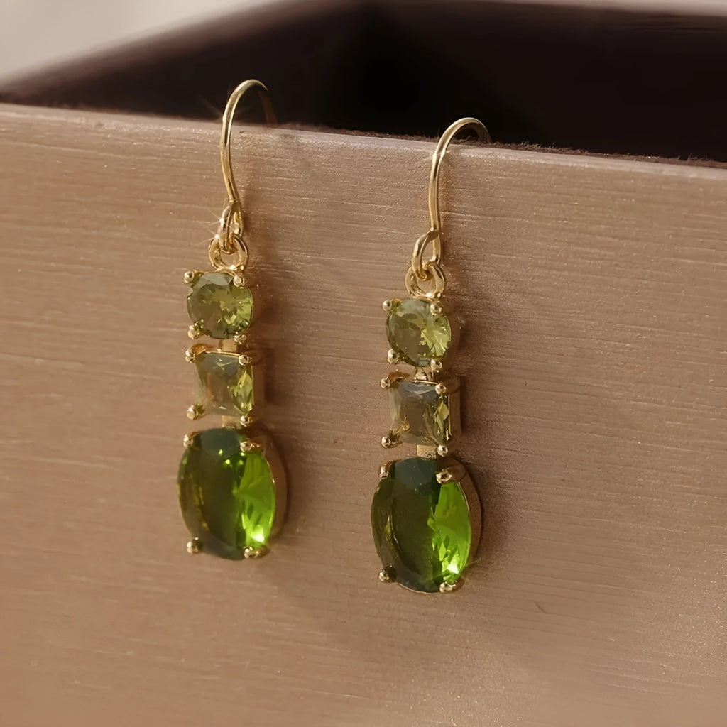 A pair of green geometric quadrilateral copper earrings in a bohemian style for unisex wear.