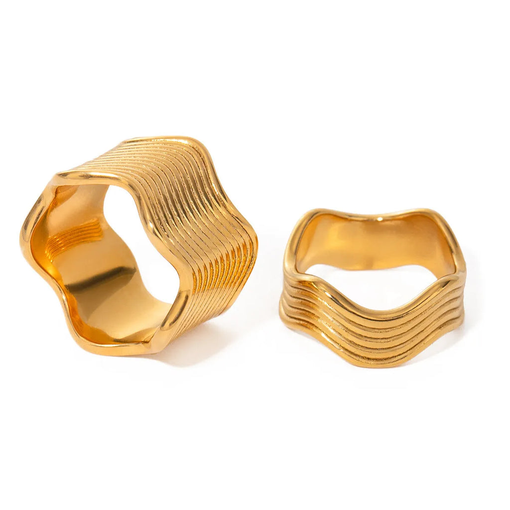 A geometric wave-design ring for women made from silver-toned stainless steel.
