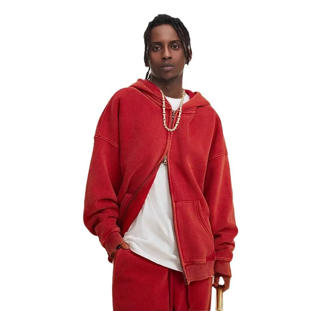 Man wearing a dark green hooded zip-up cardigan with a fleece lining and long sleeves.