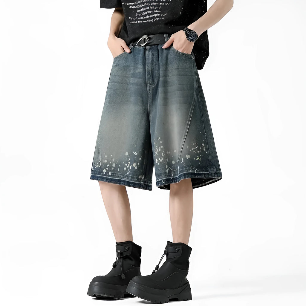 Retro blue washed denim shorts for men with ripped splash ink details and a straight leg cut.