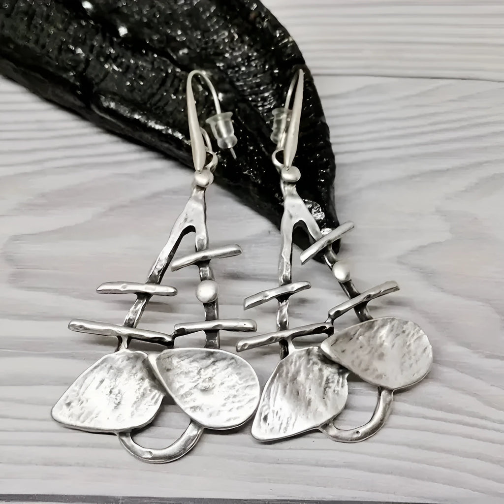 Silver alloy hollow leaf drop earrings for women with retro irregular step design and electroplated finish