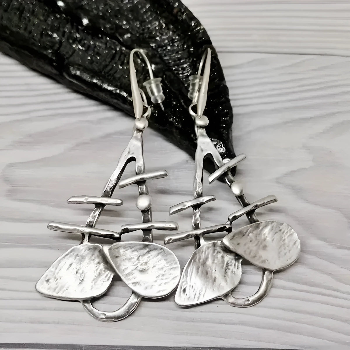 Silver alloy hollow leaf drop earrings for women with retro irregular step design and electroplated finish