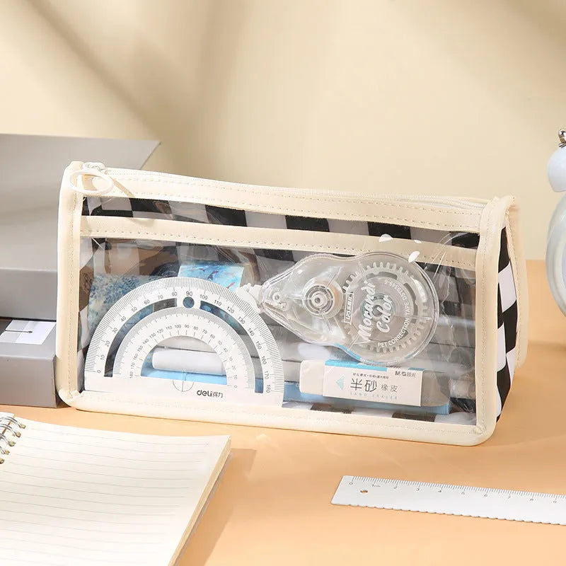 Transparent PVC pencil case with chessboard grid pattern showing pens inside, measuring 21.5cm long