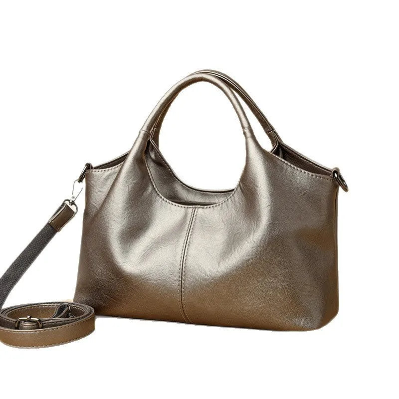 Women's soft genuine leather cross-body bag in beige colour, showing large capacity interior.
