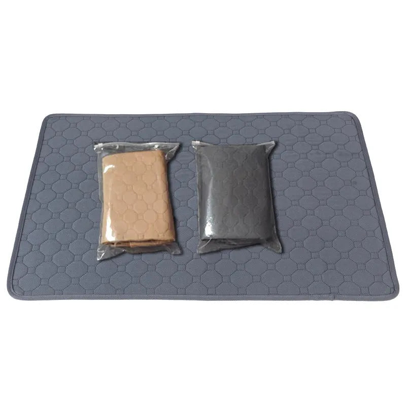 Set of two neutral-coloured washable dog pee pads on a wooden floor.